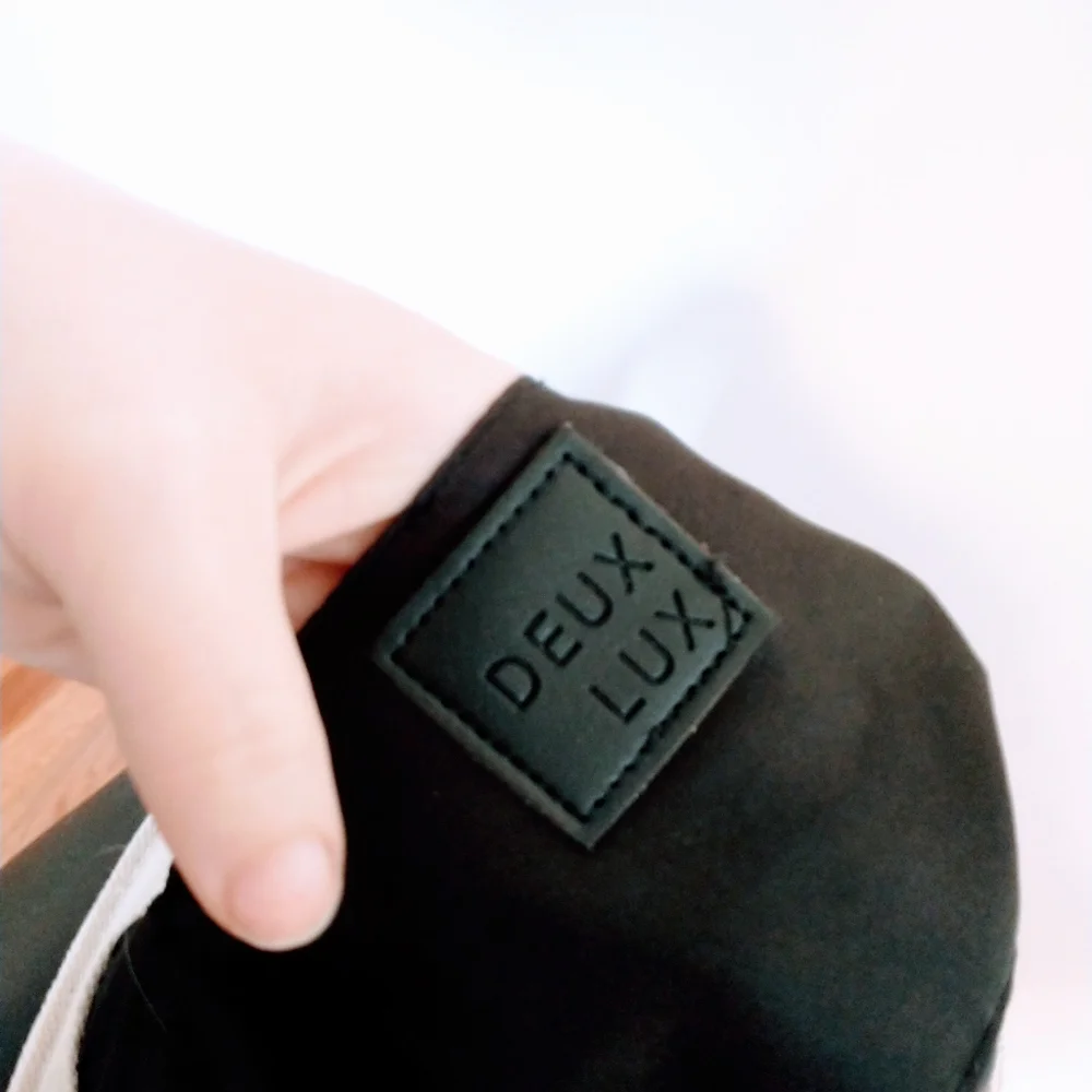 Deux Lux beige and black faux leather mini bag with buttons on the side to expan